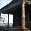 <p><strong>Colonial Revival</strong>: Elaborate main entrance with one-story porch supported by Doric columns. Officers&#39; Quarters (Building 35), view southeast, January 2007.</p>